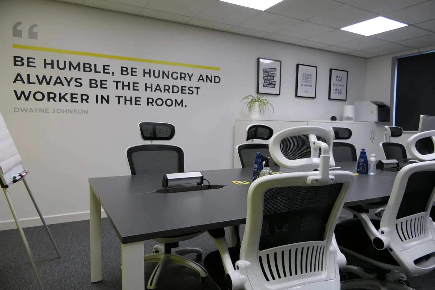 Inside the Codebreak office in Shrewsbury, with the wall quote: be humble, be hungry and always be the hardest worker in the room